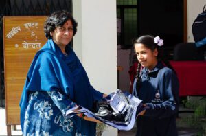 Distributing School Uniforms- AITYS